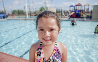 Closeup of a smiling young girl at the pool